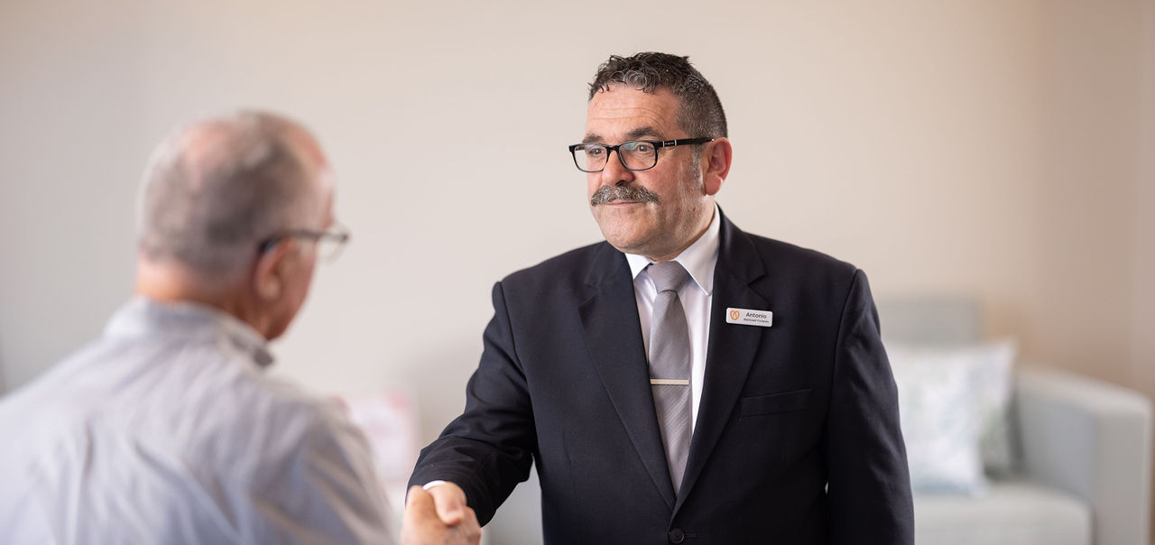 funeral director shaking hands with local man