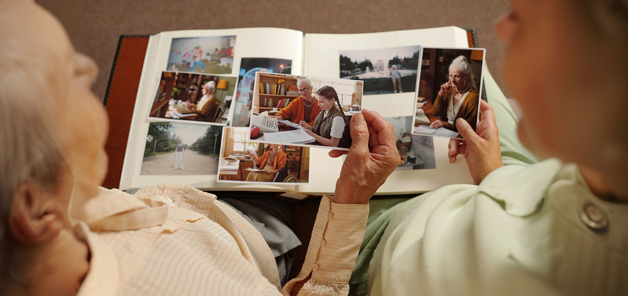 mother and daughter looking at photo album