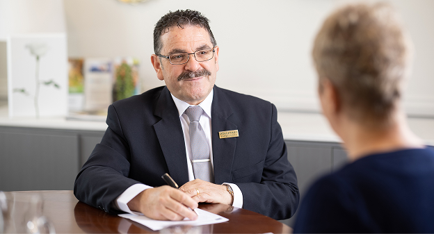 funeral director helping woman